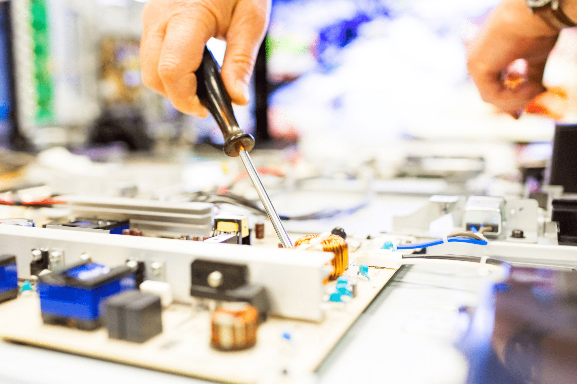 TV repair man working on big plasma televsion